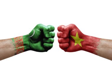 Two hands punch to each others on white background. Country flags painted fists, conflict crisis concept between turkmenistan and vietnam