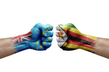 Two hands punch to each others on white background. Country flags painted fists, conflict crisis concept between tuvalu and zimbabwe