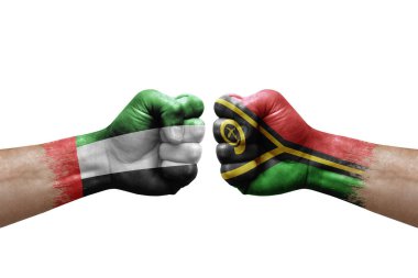 Two hands punch to each others on white background. Country flags painted fists, conflict crisis concept between uae and vanuatu
