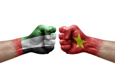 Two hands punch to each others on white background. Country flags painted fists, conflict crisis concept between uae and vietnam
