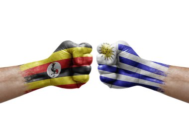 Two hands punch to each others on white background. Country flags painted fists, conflict crisis concept between uganda and uruguay