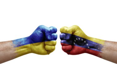 Two hands punch to each others on white background. Country flags painted fists, conflict crisis concept between ukraine and venezuela