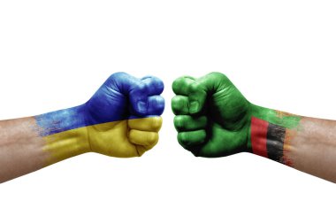 Two hands punch to each others on white background. Country flags painted fists, conflict crisis concept between ukraine and zambia