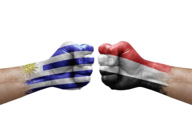 Two hands punch to each others on white background. Country flags painted fists, conflict crisis concept between uruguay and yemen