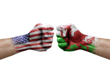 Two hands punch to each others on white background. Country flags painted fists, conflict crisis concept between usa and wales