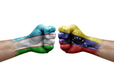 Two hands punch to each others on white background. Country flags painted fists, conflict crisis concept between uzbekistan and venezuela