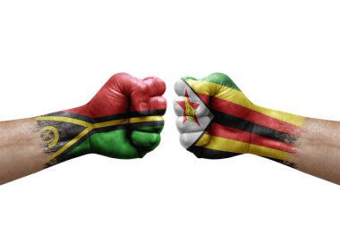 Two hands punch to each others on white background. Country flags painted fists, conflict crisis concept between vanuatu and zimbabwe