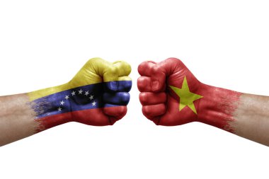 Two hands punch to each others on white background. Country flags painted fists, conflict crisis concept between venezuela and vietnam