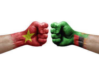 Two hands punch to each others on white background. Country flags painted fists, conflict crisis concept between vietnam and zambia
