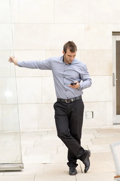 Zakenman kijken naar berichten in zijn smartphone. — Stockfoto