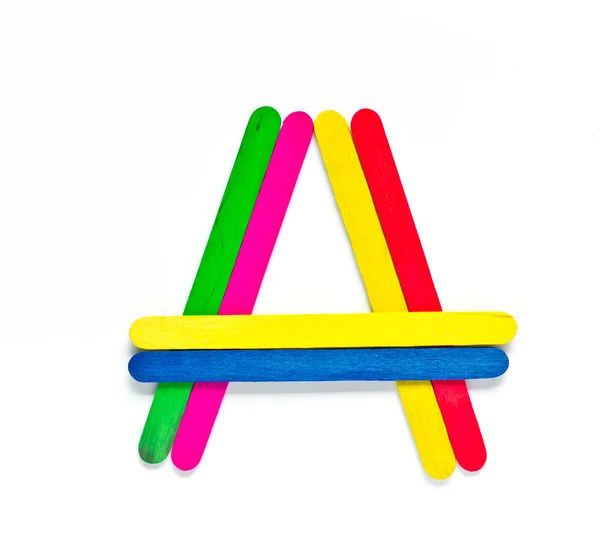 Colorful wood ice-cream stick to create A on white background. — Stock Photo, Image