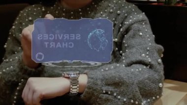 Unrecognizable woman working with HUD hologram of a smart watch with text Services Chart. Female hands with future holographic technology in wrist watches
