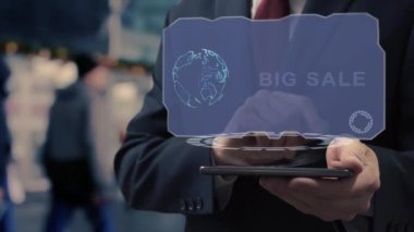 Unrecognizable businessman uses hologram on smartphone Big Sale. Man in jacket with holographic screen on background of entrance to the airport or train station
