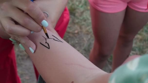 Майстри Малюють Чорні Лінії Руці Дівчат Пензлем Тимчасовим Татуюванням Розважальна — стокове відео