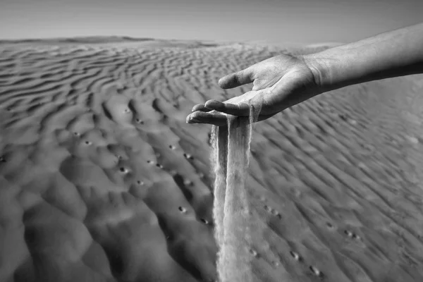 Womans hand in the sand black and white — Stock Photo, Image