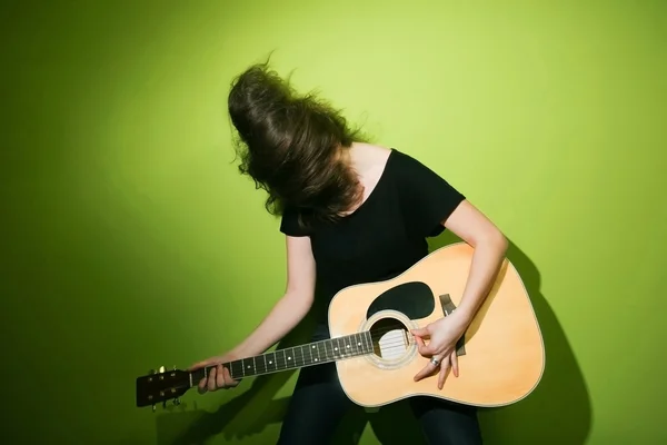 Woman passionately playing guitar — Stock Photo, Image