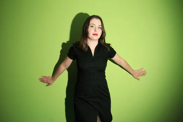 Woman posing against green background — Stock Photo, Image