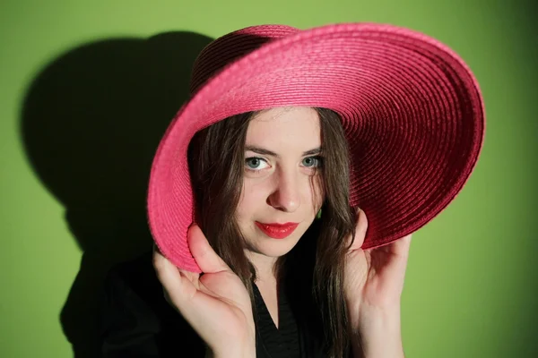 Charming girl with pink straw hat — Stock Photo, Image