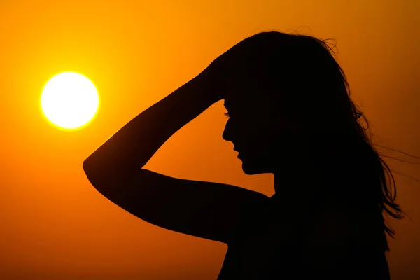 Woman silhouette on sunset — Stock Photo, Image