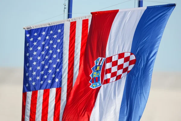 Croatian and American flags waving on white background