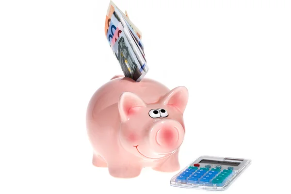 Pink piggy bank and pocket calculator — Stock Photo, Image