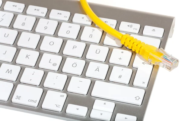 Modern keyboard and Network cable — Stock Photo, Image