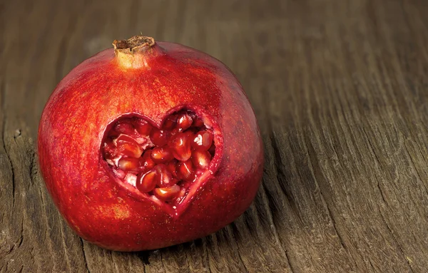 Pomegranate with heart — Stock Photo, Image
