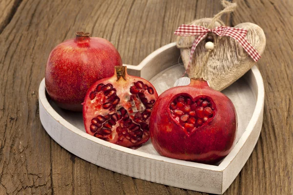Pomegranates on a wooden tray — Stock Photo, Image