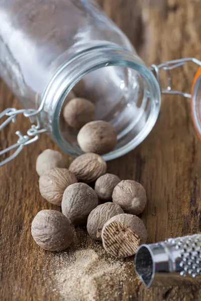Nutmegs spice in glass — Stock Photo, Image