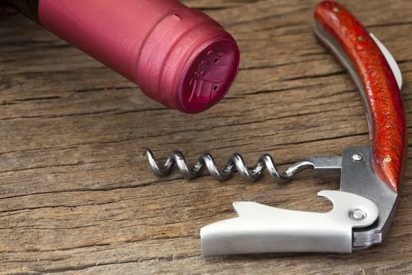 Corkscrew and wine bottle — Stock Photo, Image