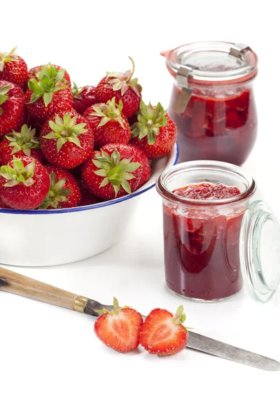 Fresh strawberries and jam jars — Stock Photo, Image