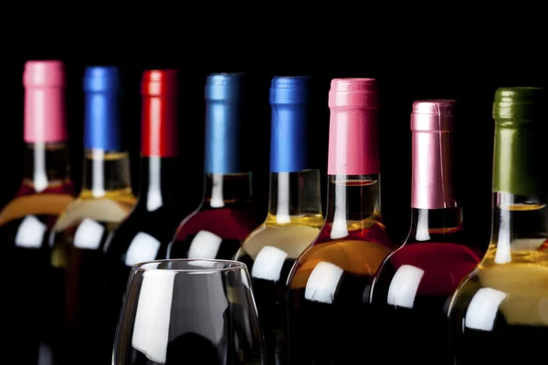 Some wine bottles and a wineglass — Stock Photo, Image