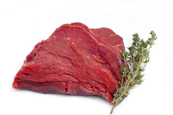 One Piece raw Beef Tenderloin with a twig Thyme — Stock Photo, Image