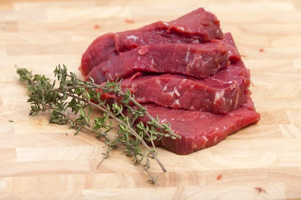 Four Slice Beef Tenderloin with a twig Thyme — Stock Photo, Image