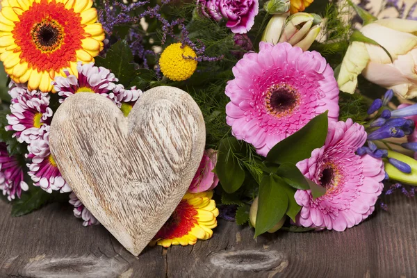 Flower Greetings with a Wooden Heart — Stock Photo, Image