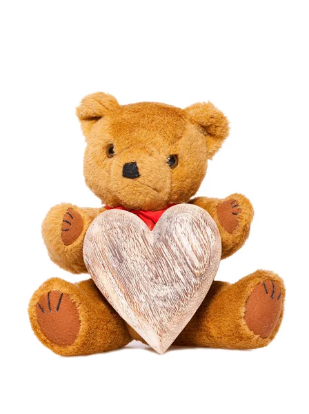 Uppstoppade djur teddy med ett hjärta av trä — Stockfoto