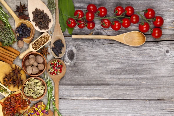 Herbs and spices on wooden background — Stock Photo, Image