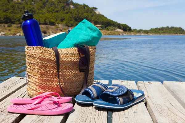 With a book by the swimming lake — Stock Photo, Image