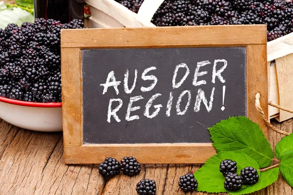 Slate blackboard with the Germans words: Aus der Region — Stock Photo, Image