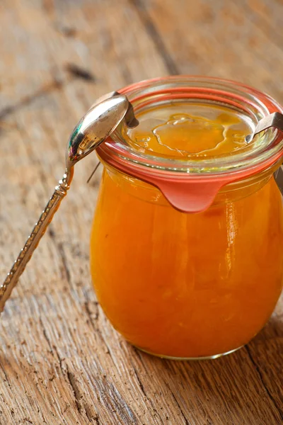 Melon jam in a preserving jar with a spoon — Stock Photo, Image