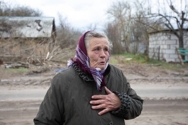 An elderly woman cries near her destroyed house after the Ukrainian army liberated her village from Russian occupiers in Kyiv region, Ukraine. April 21, 2022.