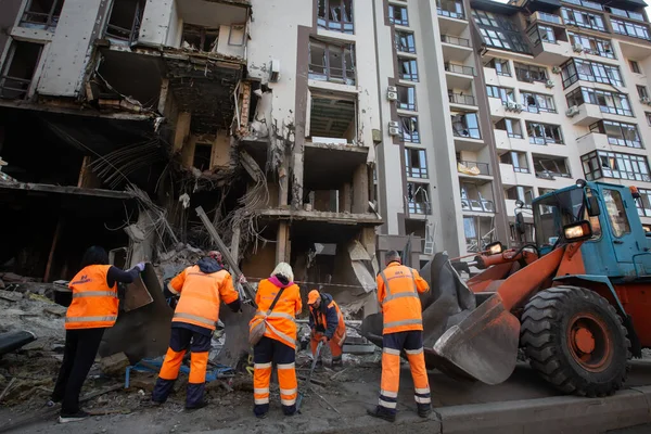 Communal workers clean an area around an apartment building destroyed in a military strike amid Russia's invasion of Ukraine in Kyiv, Ukraine. April 29, 2022.