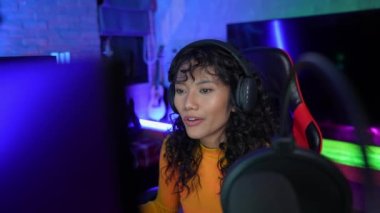 Tatil konsepti 4k Çözünürlük. Asyalı kadınlar çevrimiçi radyo programı sunuyorlar. Disk jokeyi. DJ mikrofonla konuşuyor..