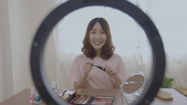 Tatil konsepti 4k Çözünürlük. Asyalı kızlar evde internette makyaj öğretiyor..