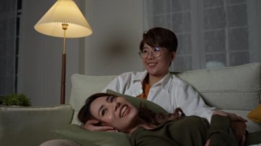 Tatil konsepti 4k Çözünürlük. Evde birlikte film izleyen Asyalı kadınlar. Eğlenceli ve heyecan verici eğlence aktiviteleri.