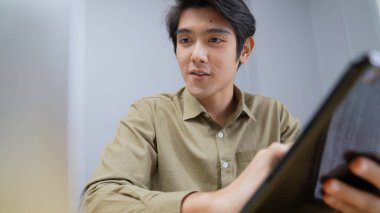 Holiday concept of 4k Resolution. Asian man working from home. computer data entry.