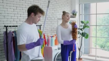 Family concept of 4k Resolution. Caucasian couple having fun cleaning the house.