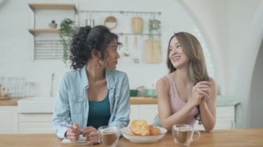 Tatil konsepti 4k Çözünürlük. Asyalı kadınlar mutfakta kahve içiyorlar. Genç kadınların ortak bir lezbiyen ilişkisi var..