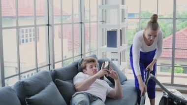 Family concept of 4k Resolution. Caucasian couple cleaning in the house. taking advantage.