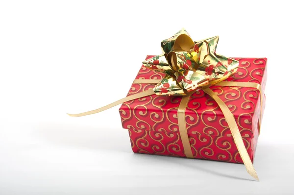 Red giftbox with golden bow — Stock Photo, Image